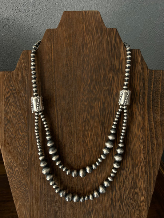 Double strand graduated barrel bead